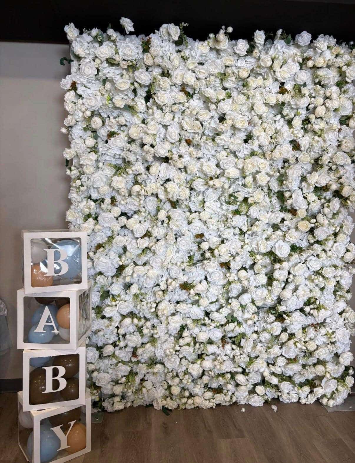 White flower wall backdrop at a baby shower