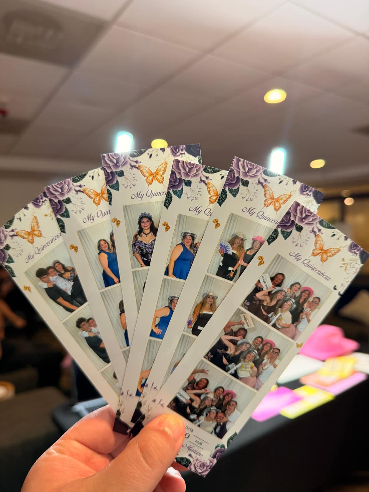 A handful of custom quinceañera photo strips fresh from the printer